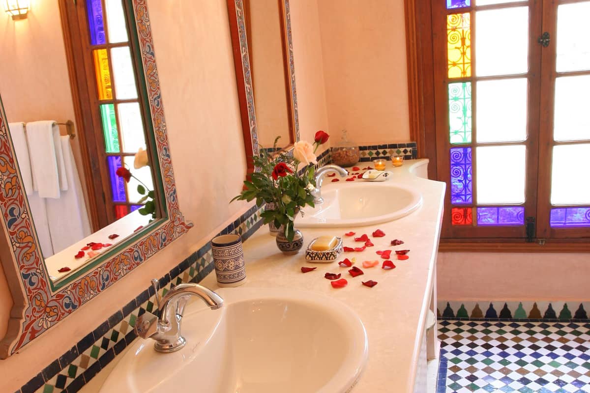 deluxe suite, jetted tub | bathroom | deep-soaking bathtub, free toiletries, hair dryer, bathrobes