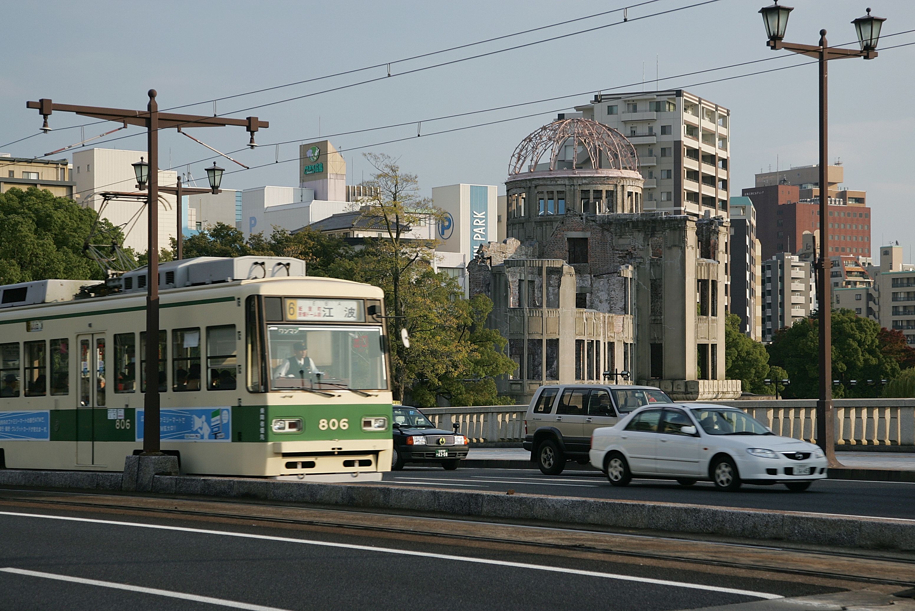 A tram with the number 806 on a city street.