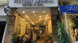 The exterior of Victory Legend Hotel & Spa, featuring a modern facade, a visible entrance, and a signboard. - Victory Legend Hotel & Spa (Hanoi)