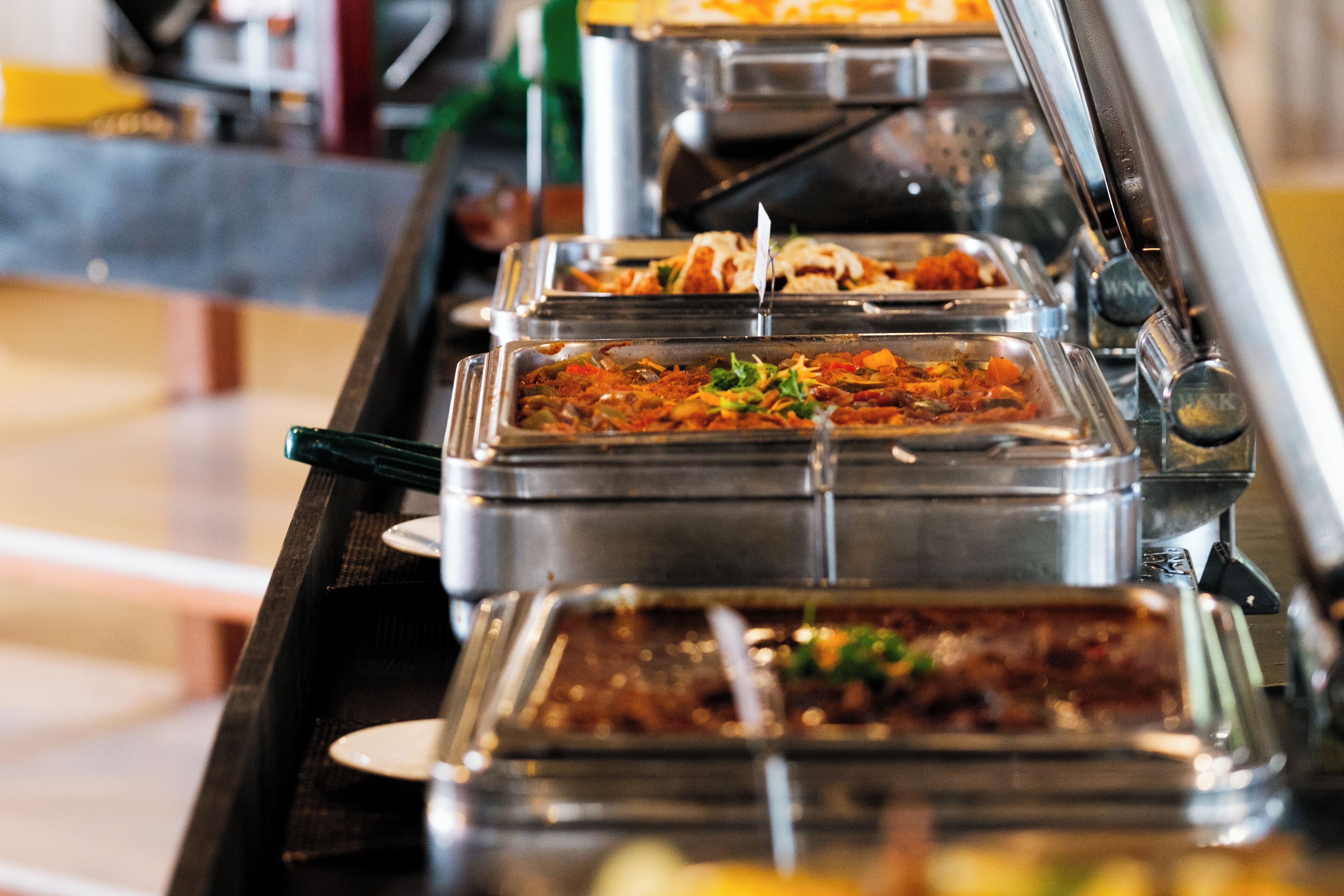 A buffet with various food items in clear containers.