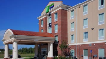 A Holiday Inn Express hotel with a covered entrance, brick facade, and multiple windows.