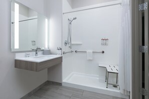 A modern bathroom with a large mirror, two sinks, a bathtub, and a shower. - Holiday Inn Express & Suites Marshall by IHG (Marshall)