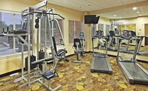 A gym with various exercise equipment, including a treadmill, elliptical, and weight machines. - Holiday Inn Express & Suites Marshall by IHG (Marshall)