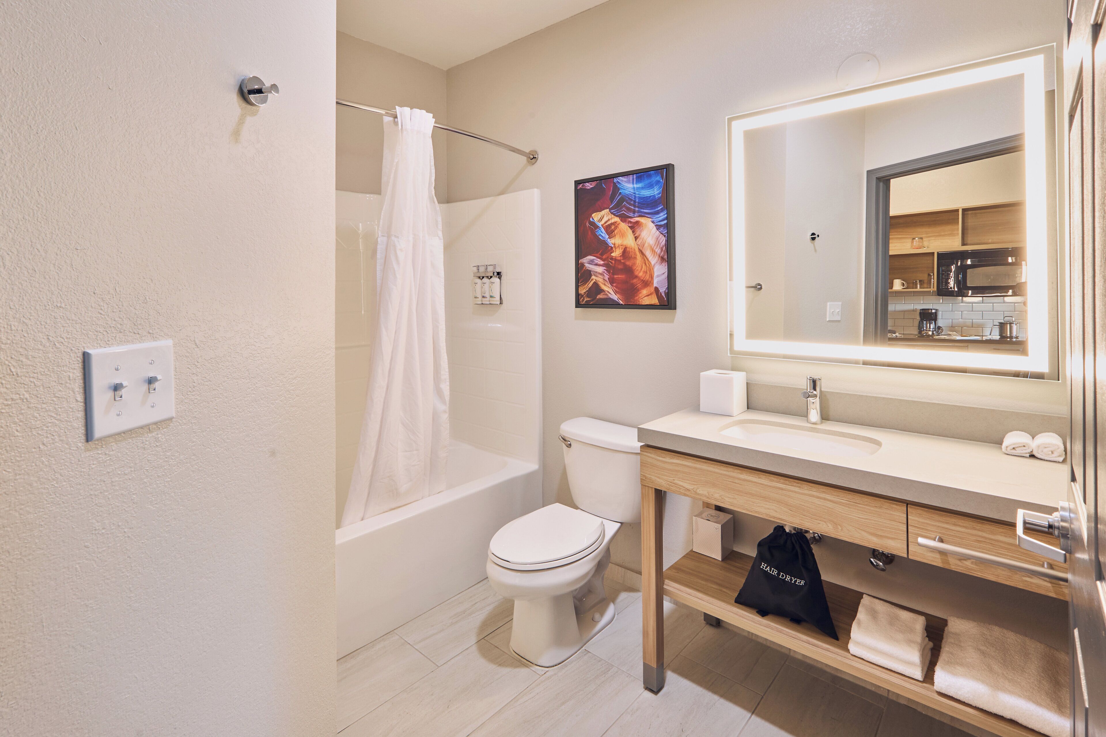 A modern bathroom with a bathtub, toilet, and sink.