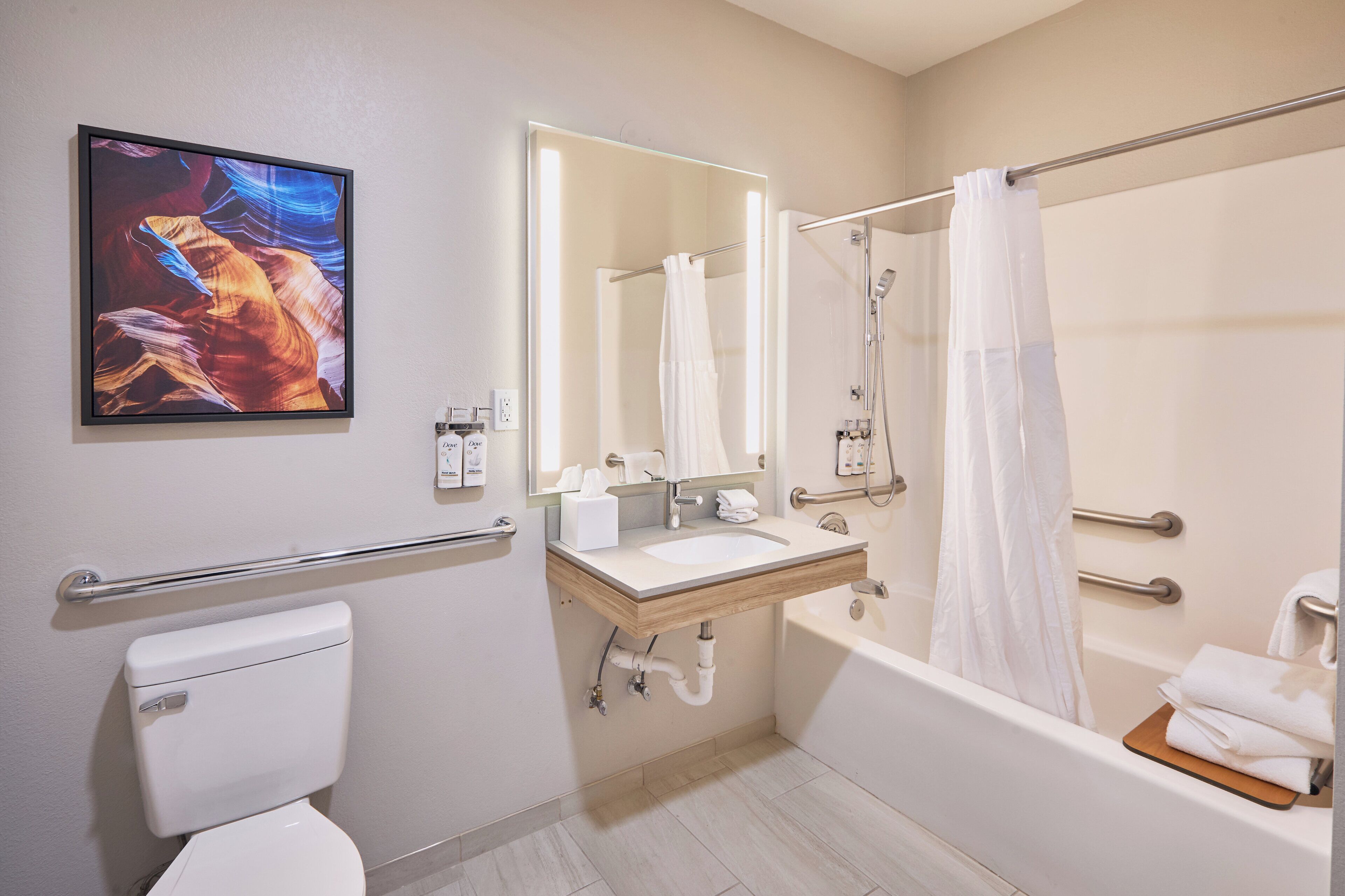 A modern bathroom with a toilet, sink, and bathtub.