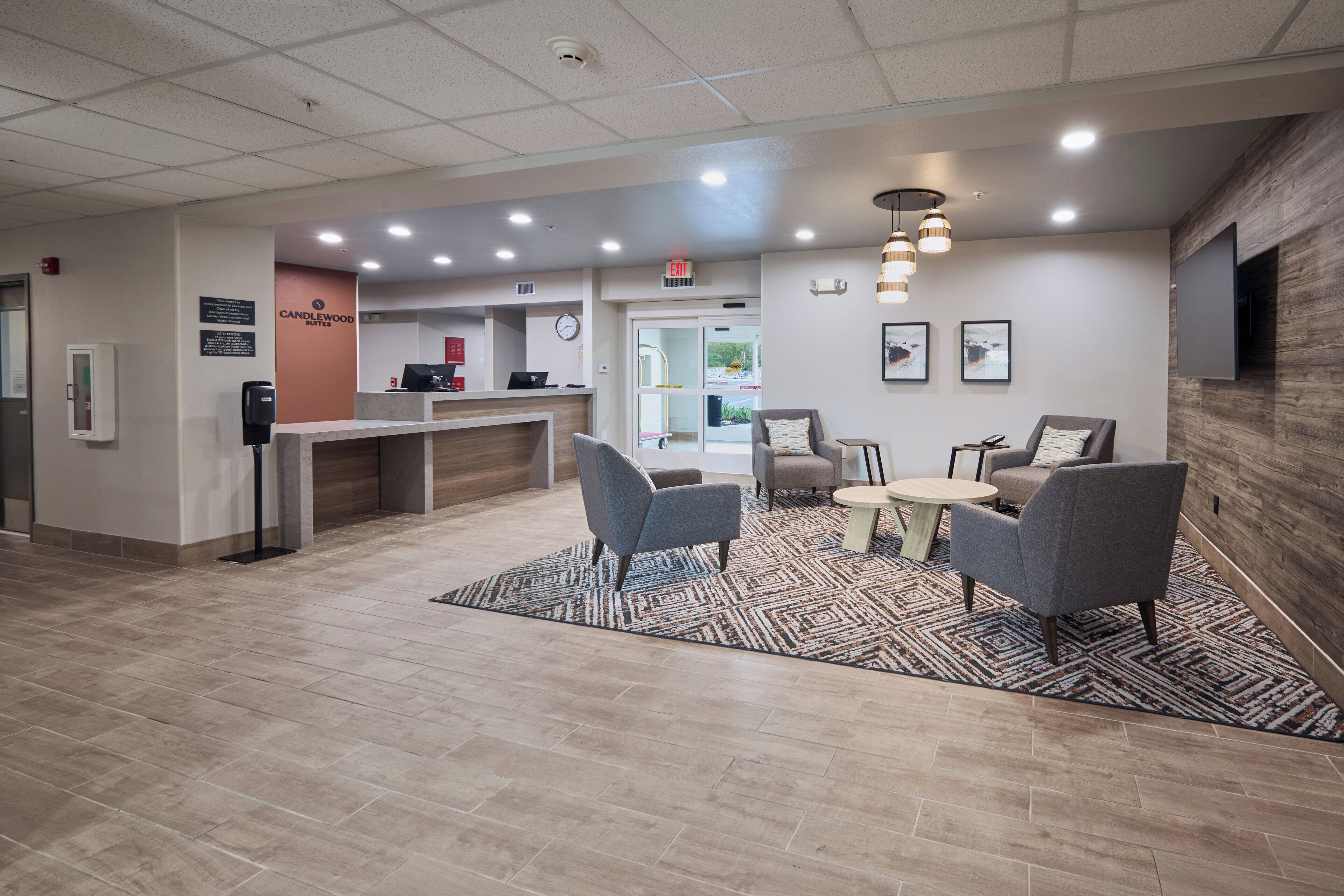 A reception area with a counter, seating, and a clock.