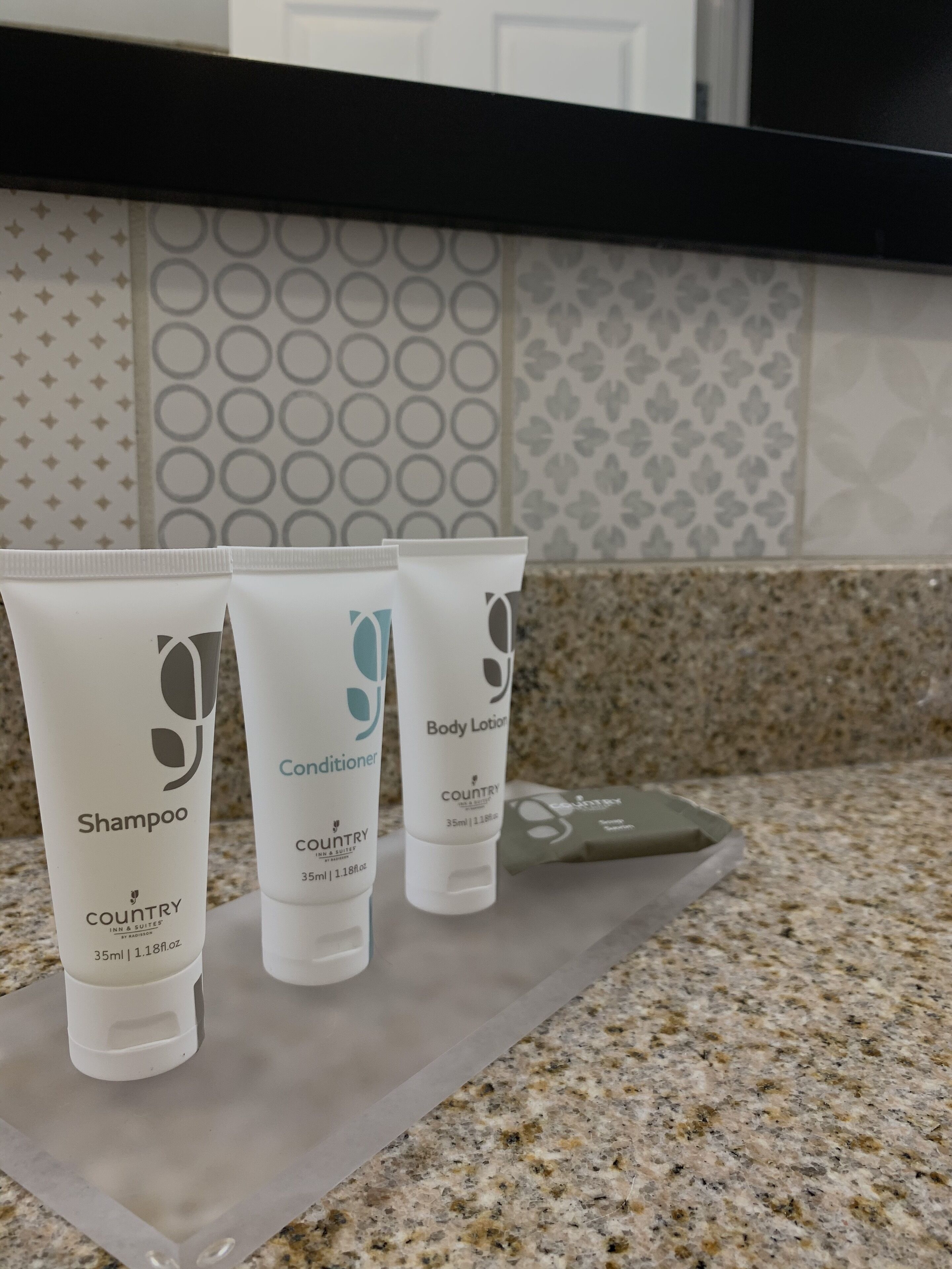 Three toiletry bottles on a countertop.