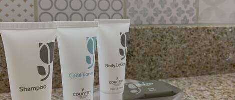 Three toiletry bottles on a countertop.