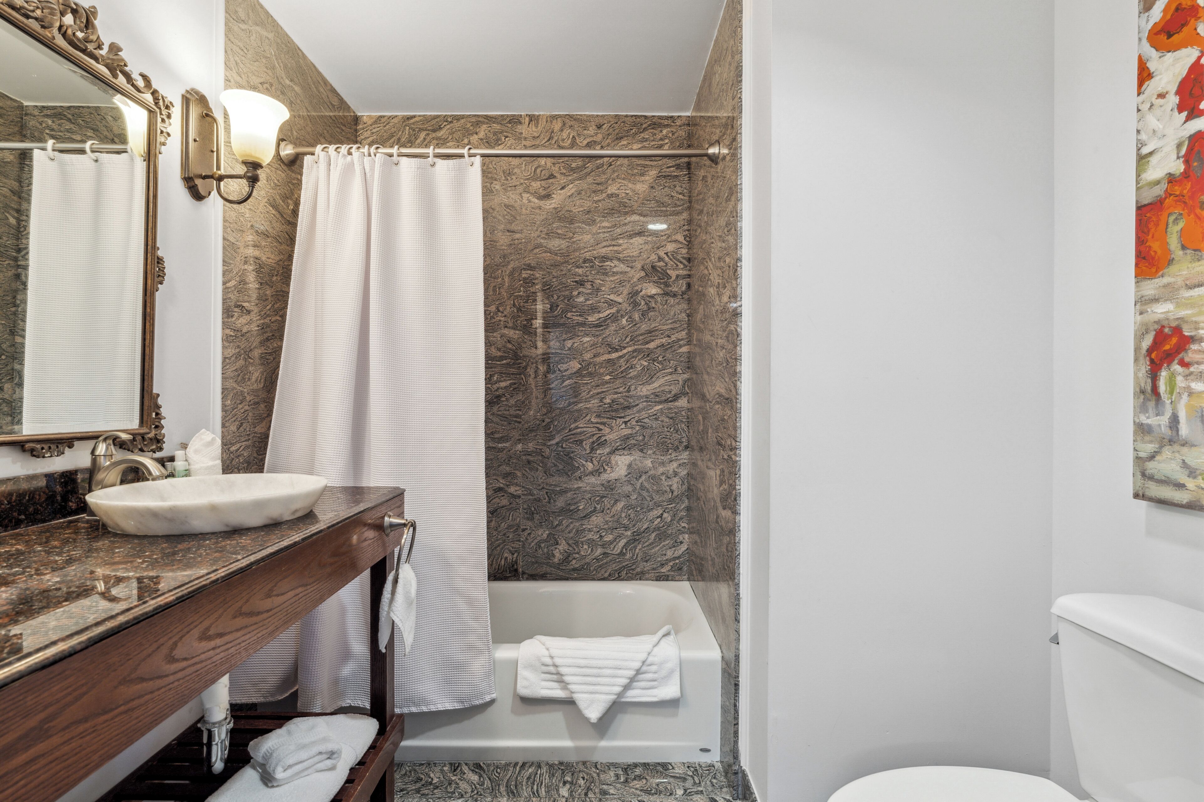 combined shower/bathtub, designer toiletries, hair dryer, towels