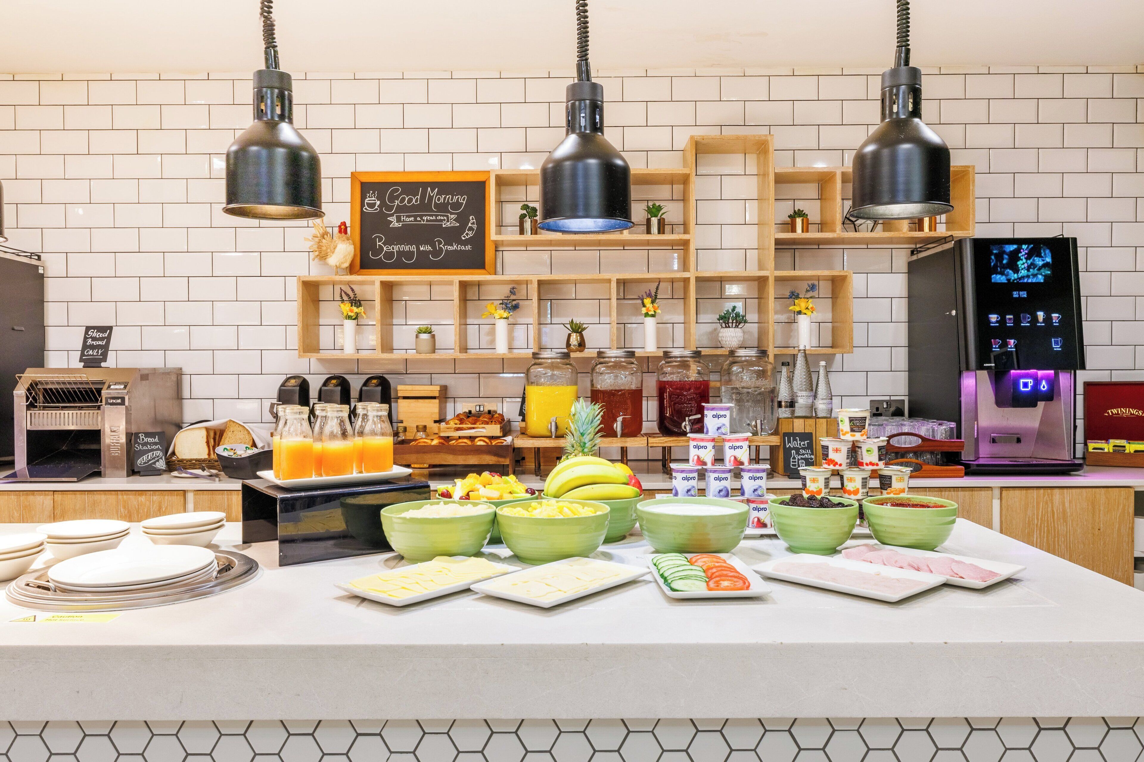 A breakfast buffet with various food items and a coffee machine.