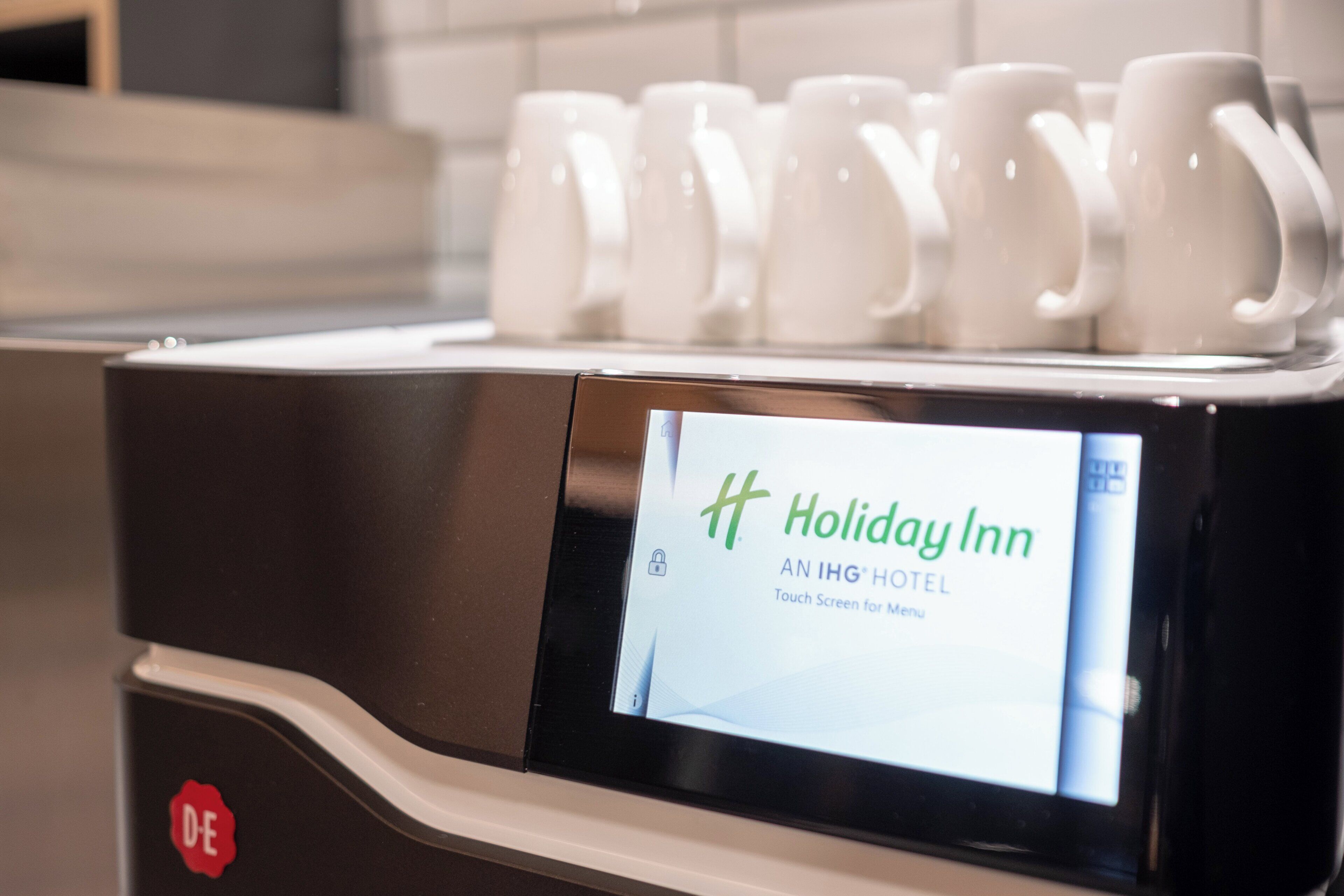 A touch screen display on a hotel service station with the Holiday Inn logo.