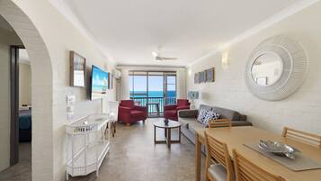Deluxe Apartment, 2 Bedrooms, Ocean View | Living area | TV, books