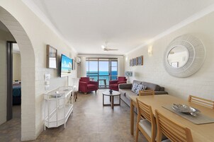 Deluxe Apartment, 2 Bedrooms, Ocean View | Living area | TV, books