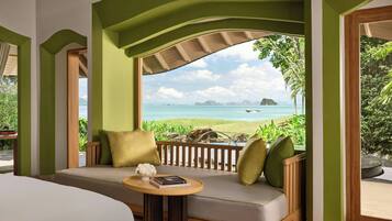 Relax in a serene space with a scenic ocean view, a comfortable seating area, and a large window.