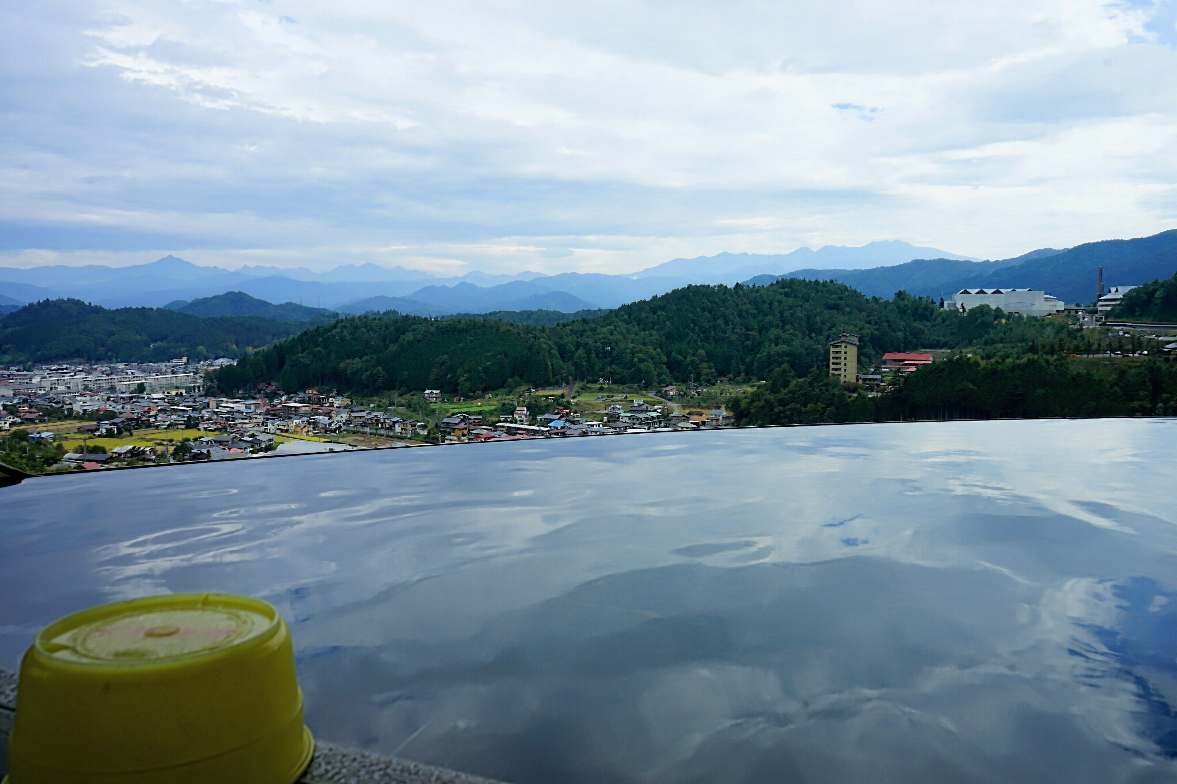 A panoramic view of a mountainous landscape with a town in the valley below.