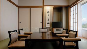A traditional Japanese-style room with tatami flooring, a low table, and shoji screens.