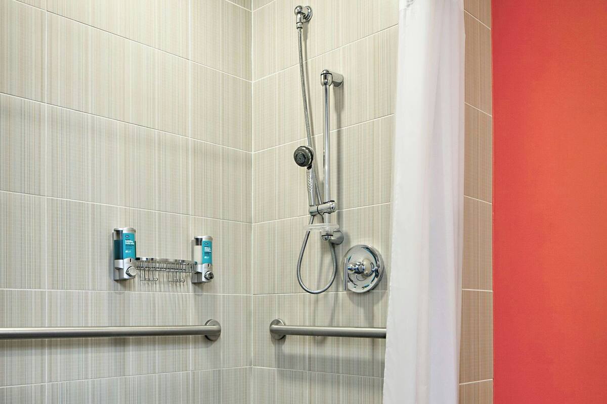 shower, designer toiletries, hair dryer, towels