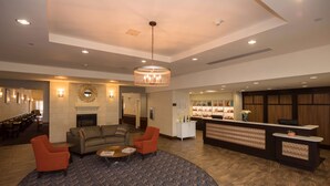 A spacious lobby with a fireplace, seating area, and a reception desk. - Homewood Suites by Hilton San Antonio North (San Antonio)