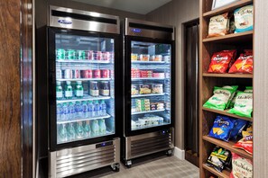Two refrigerated display cases stocked with beverages and snacks.