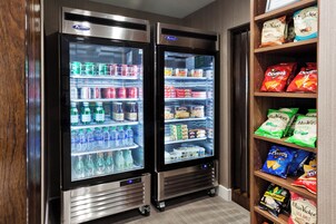 Dos vitrinas refrigeradas llenas de bebidas y aperitivos.