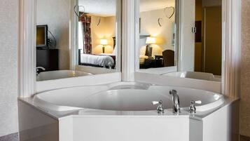 Bathroom features a bathtub and a mirror reflecting the room's interior.