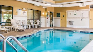A swimming pool with a tiled edge, a pool ladder, and lounge chairs. - Comfort Suites Canton - Detroit (Canton)