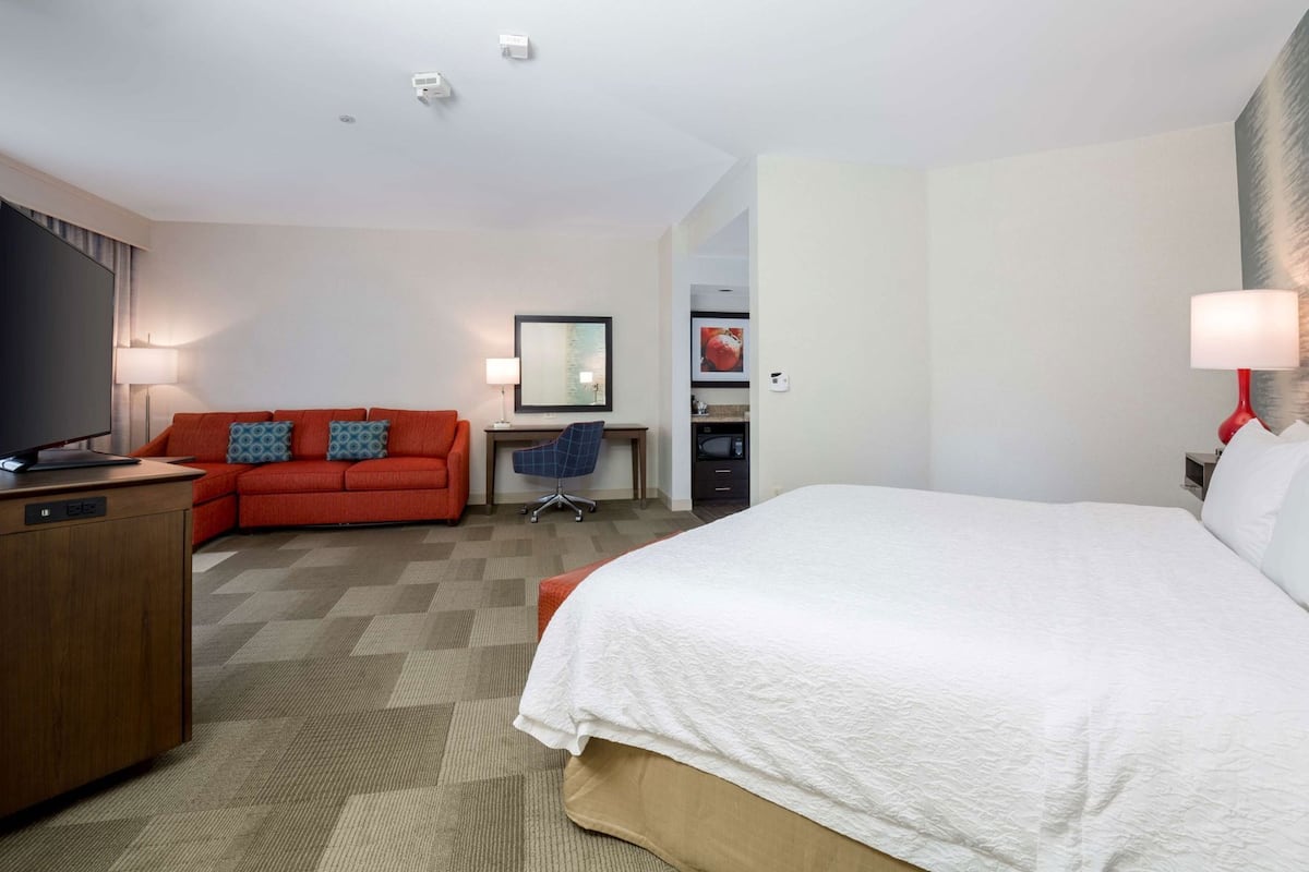 Premium bedding, desk, laptop workspace, blackout drapes