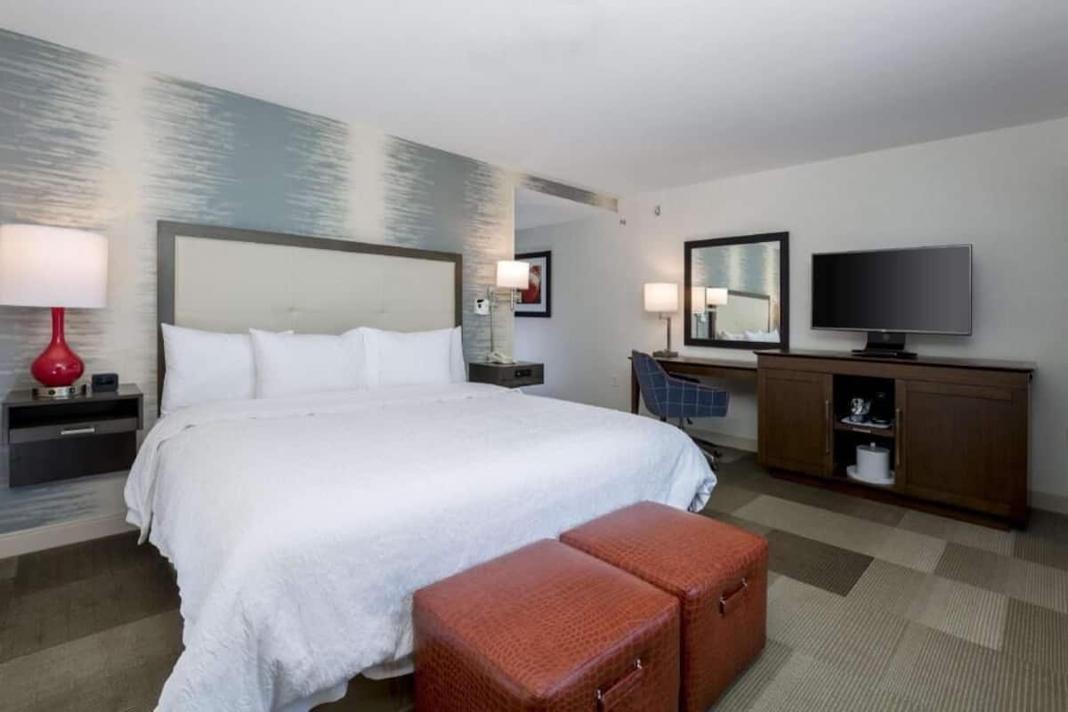 Premium bedding, desk, laptop workspace, blackout drapes