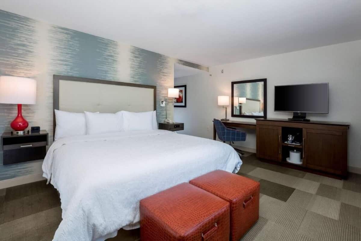 Premium bedding, desk, laptop workspace, blackout drapes