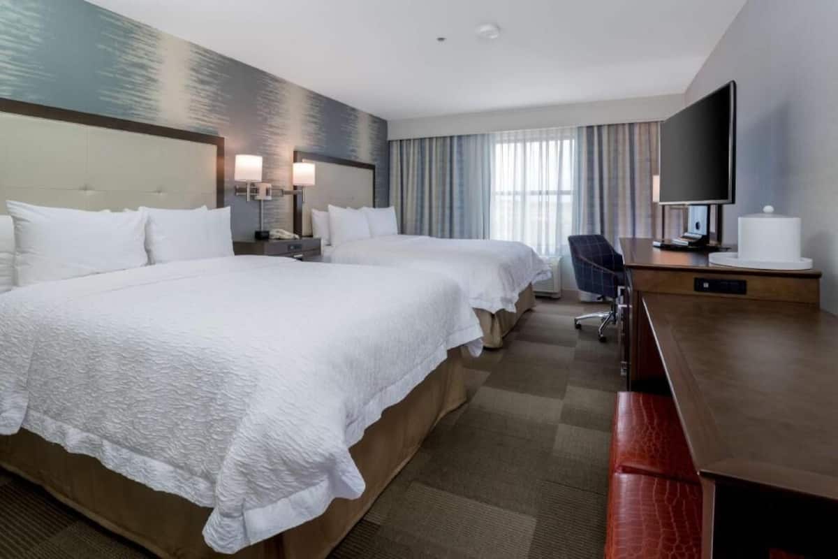 Premium bedding, desk, laptop workspace, blackout drapes