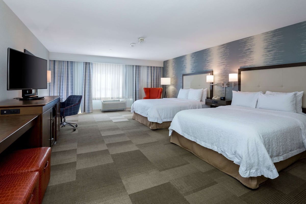 Premium bedding, desk, laptop workspace, blackout drapes