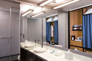 Shower, designer toiletries, hair dryer, towels