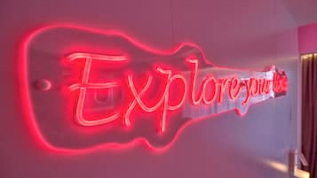 A neon sign with the text 'Explore your' in a stylized font.