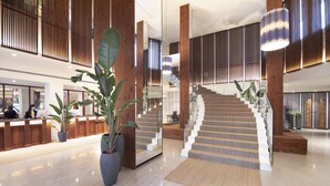 A spacious lobby with a staircase, wooden columns, and potted plants. - Cabot Pollensa Park Spa - Family Resort (Pollenca)