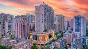A high-rise hotel with multiple floors, a prominent sign, and a surrounding urban skyline. - Landmark International Hotel (Guangzhou)