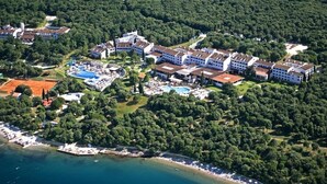 An aerial view of a resort with multiple buildings, a swimming pool, and a beach area. - Valamar Tamaris Villas (Tar-Vabriga)