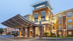 A modern hotel with a covered entrance, multiple floors, and a prominent "CAMBRIA" sign. - Cambria Hotel Akron - Canton Airport (Uniontown)