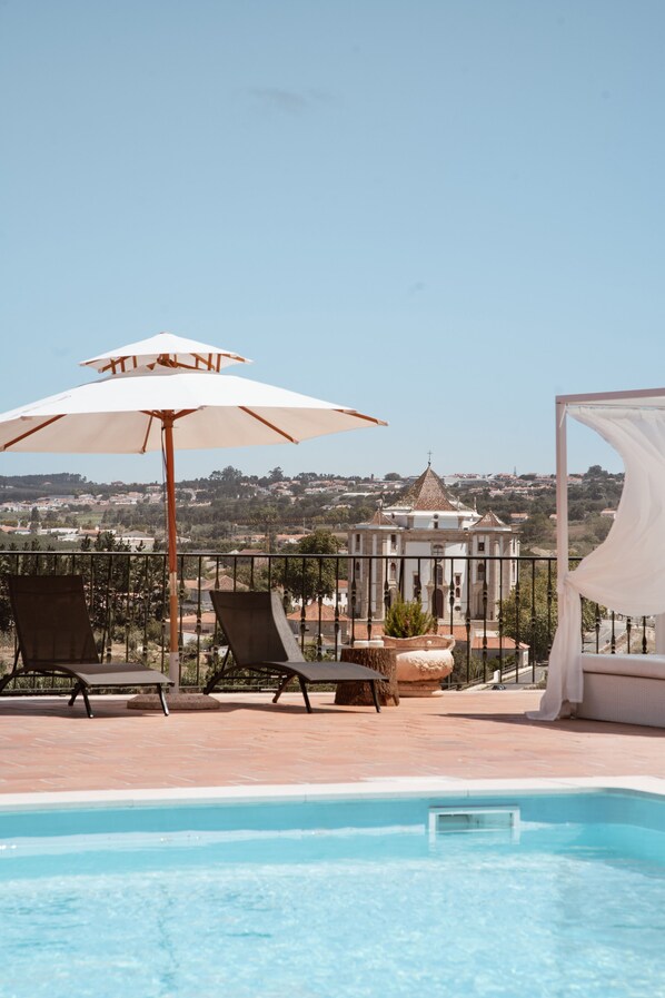 Seasonal outdoor pool, open 10 AM to 8 PM, pool umbrellas, pool loungers