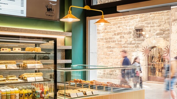 Une vitrine de boulangerie présentant diverses pâtisseries et boissons.