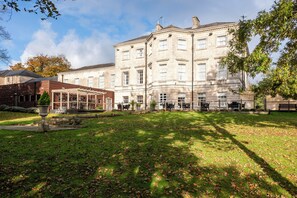 A large, historic building with a central courtyard, surrounded by a well-maintained lawn and trees. - Aston Hall Hotel, BW Signature Collection (Sheffield)