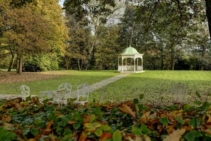 A gazebo in a park with a pathway leading to it, surrounded by trees and benches. - Aston Hall Hotel, BW Signature Collection (Sheffield)