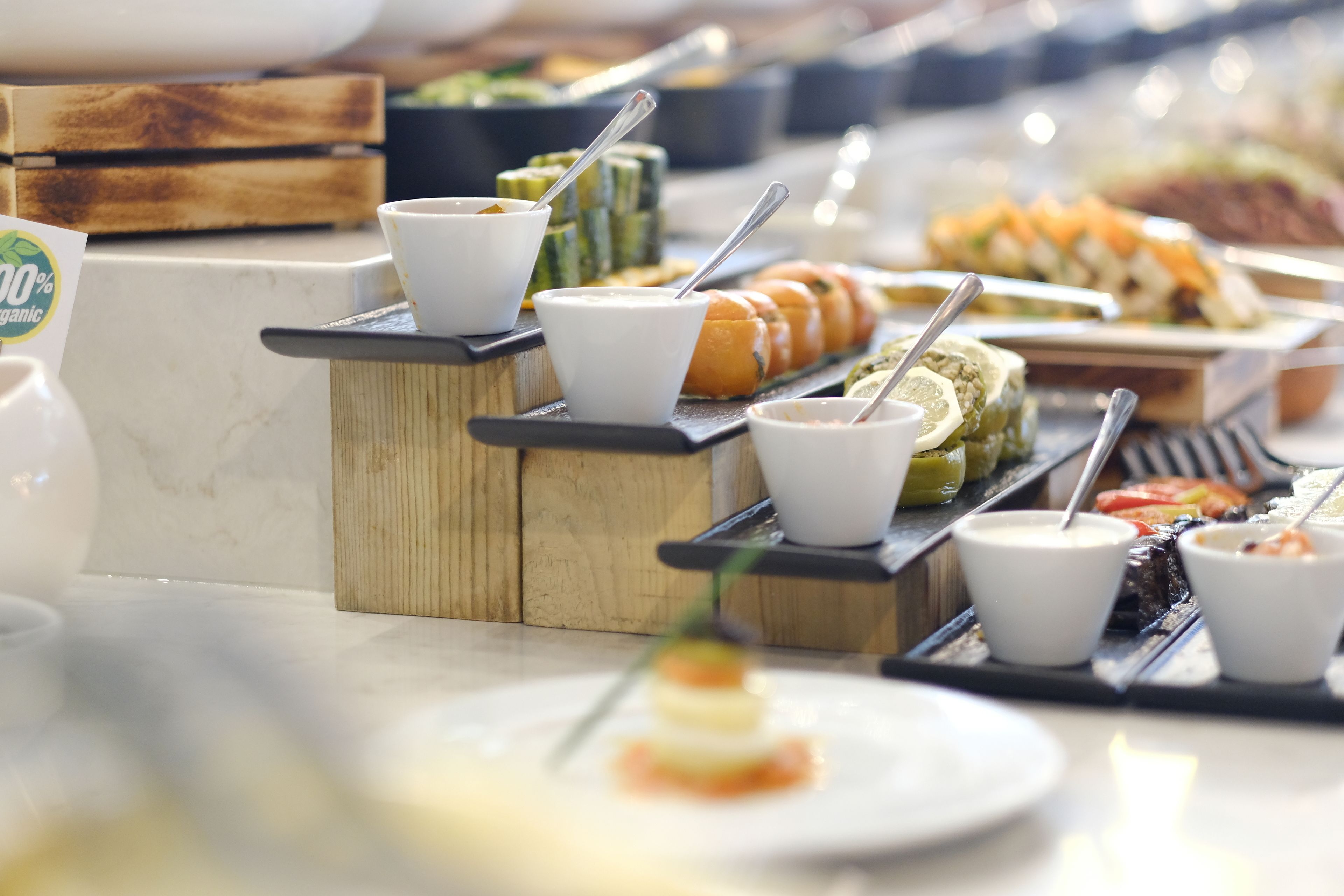 A buffet with various food items and condiments.