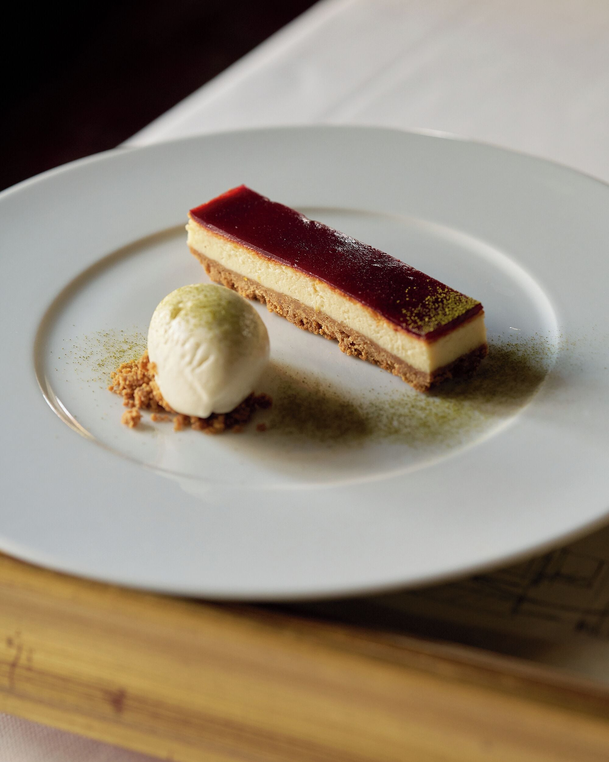 A dessert on a plate with a scoop of ice cream beside it.
