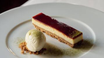 A dessert on a plate with a scoop of ice cream beside it.