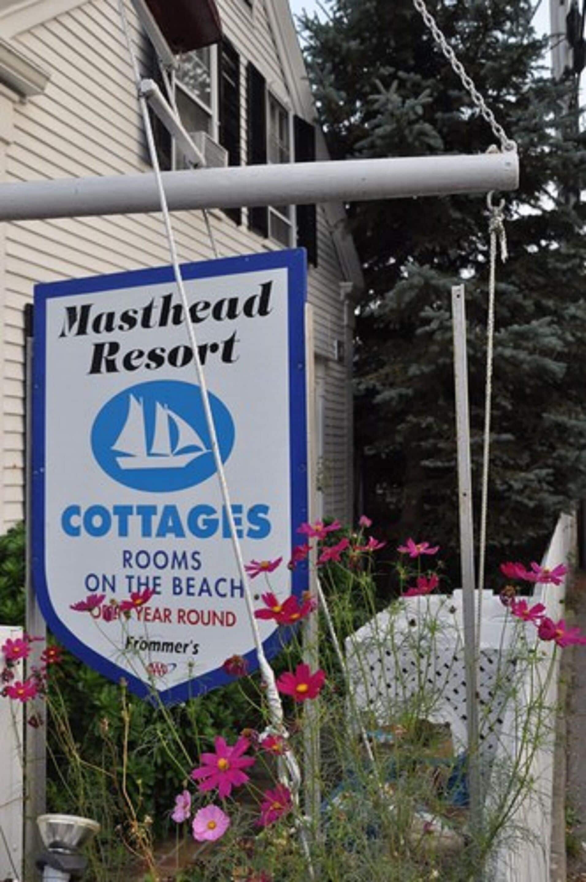 A sign for Masthead Resort cottages on the beach, indicating year-round availability.