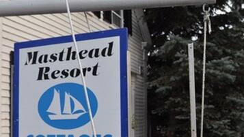 A sign for Masthead Resort cottages on the beach, indicating year-round availability.