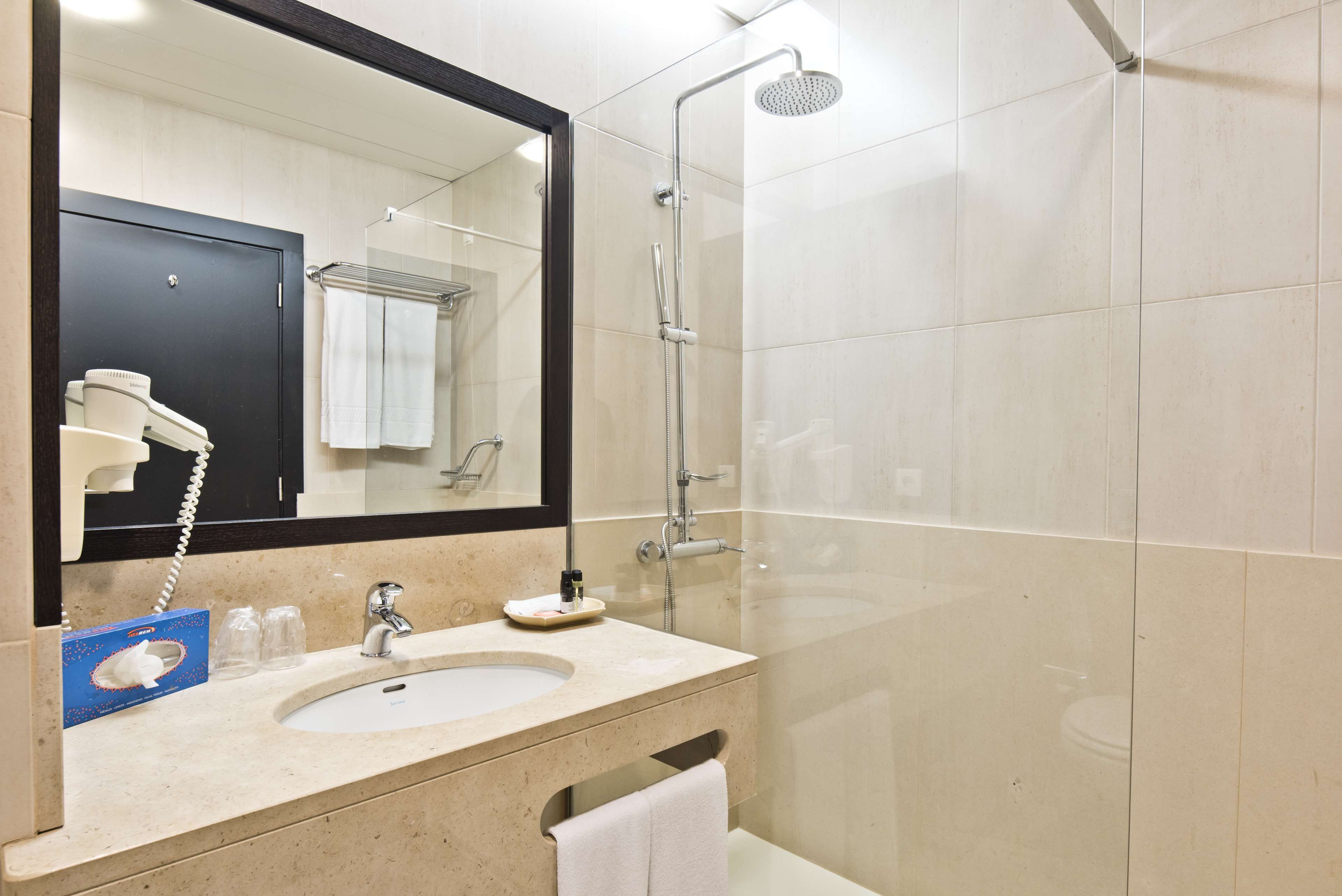 bathtub, rainfall showerhead, eco-friendly toiletries, hair dryer