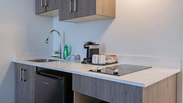 A modern kitchen with a dishwasher, a coffee machine, and a sink.