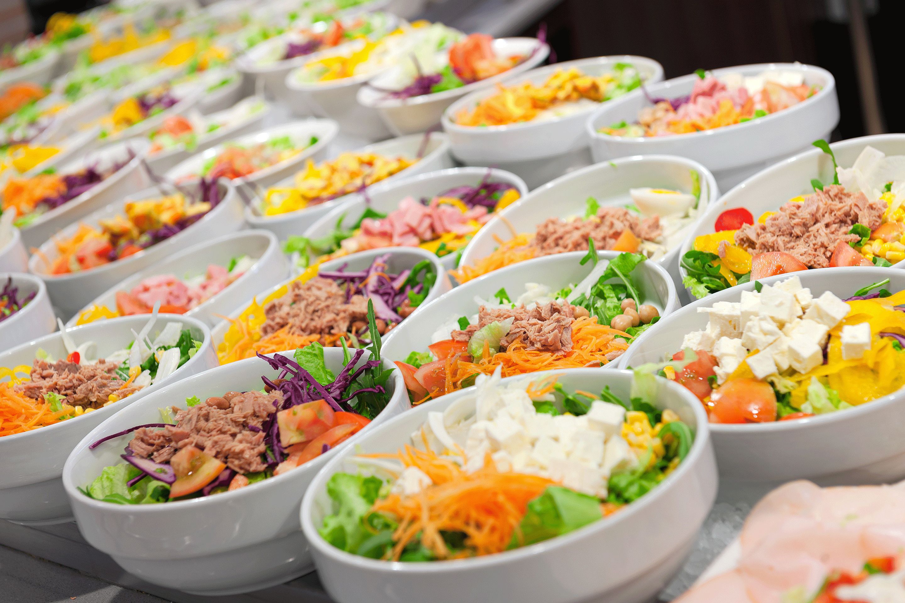 A variety of salad bowls with different ingredients.