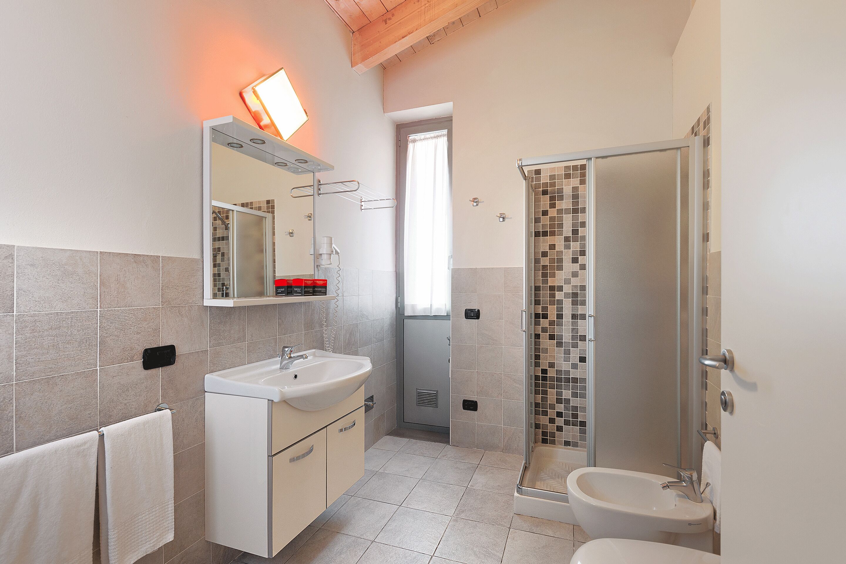 Un baño moderno con ducha, lavabo e inodoro.